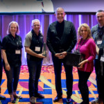Randy Karnes stands with members of TruChoice Federal Credit Union, winner of the 2019 Spirit of CU*Answers Award.